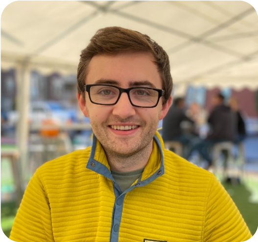 a man wearing glasses and a yellow jacket.