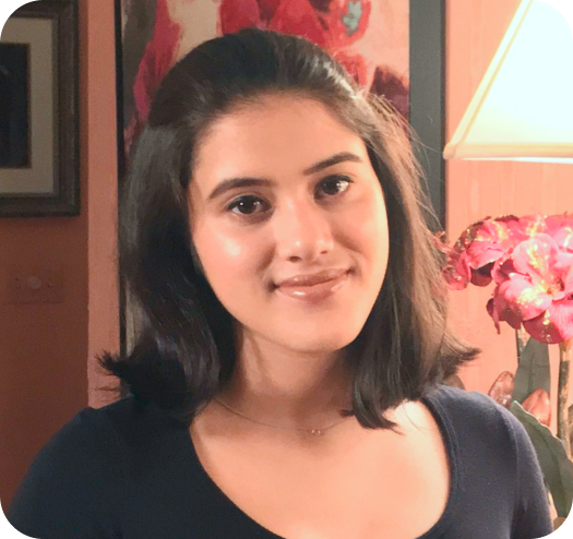 a woman in a room with a vase of flowers.